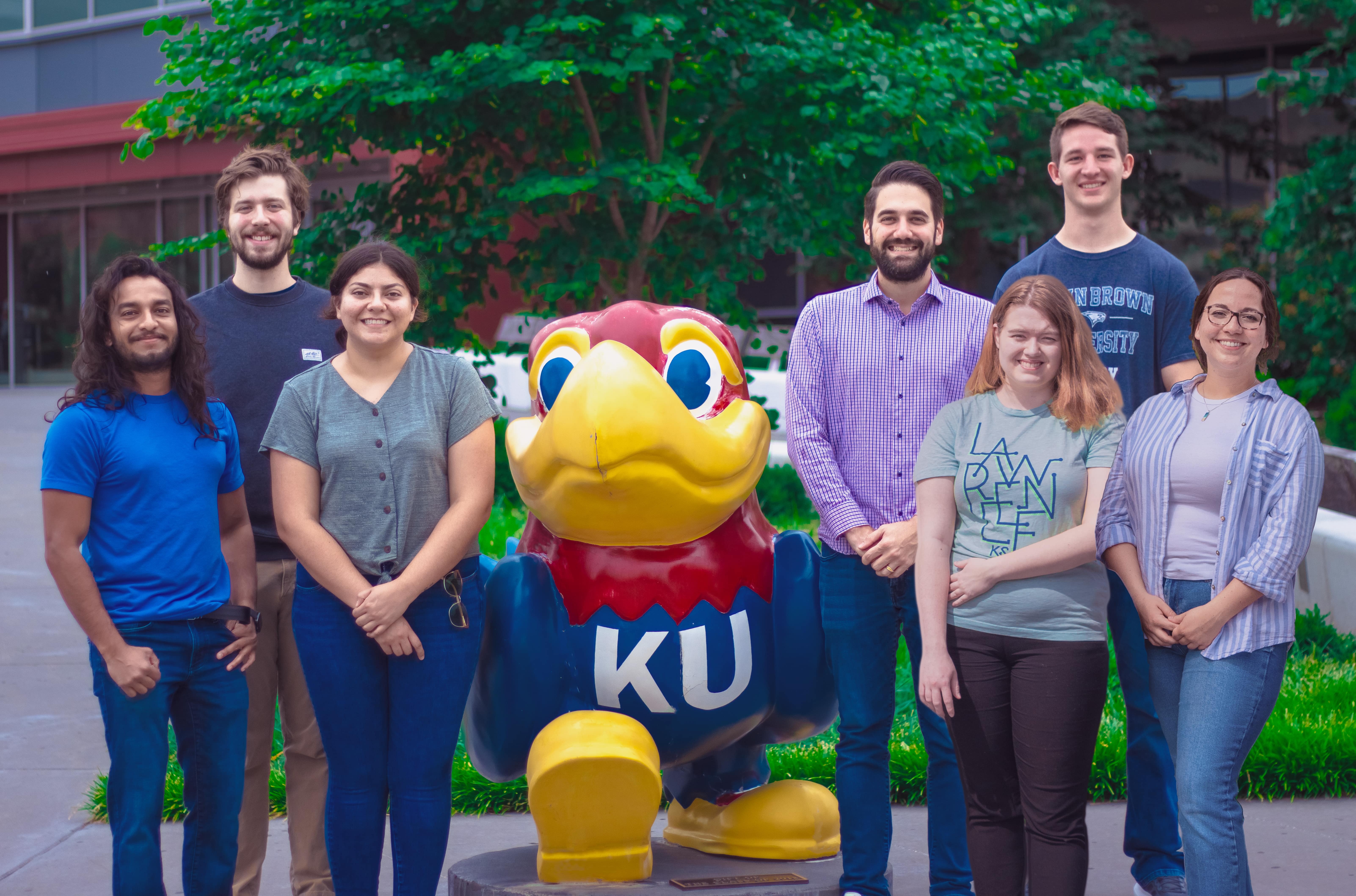 Teator Lab standing next to Jayhawk, smiling at the camera