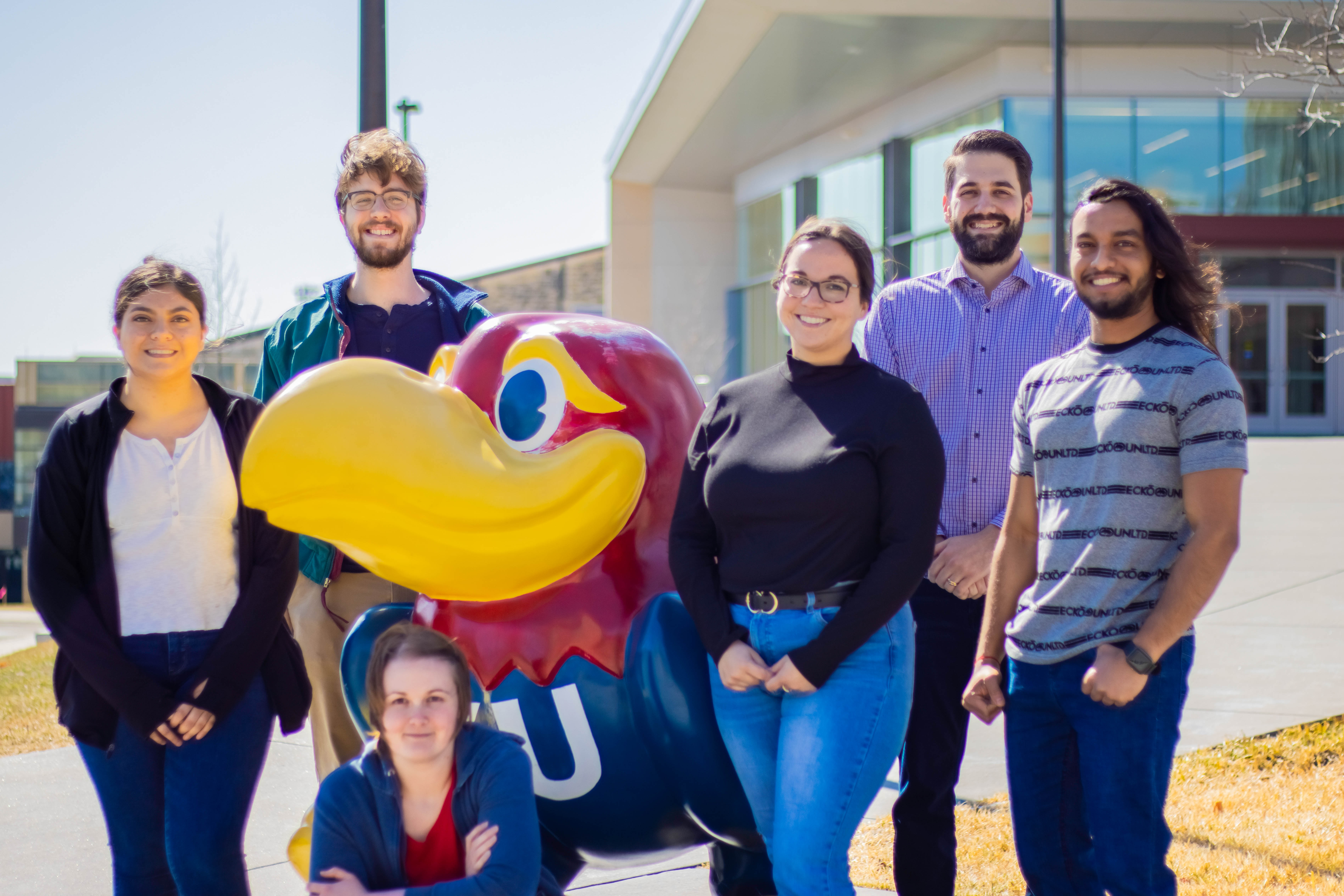 Teator Lab standing next to Jayhawk, smiling at the camera