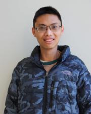 Photo of Keith Huang, smiling at the camera