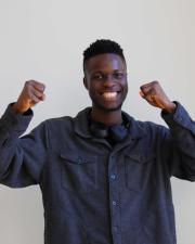 Photo of Peace Adelowokan, smiling at the camera